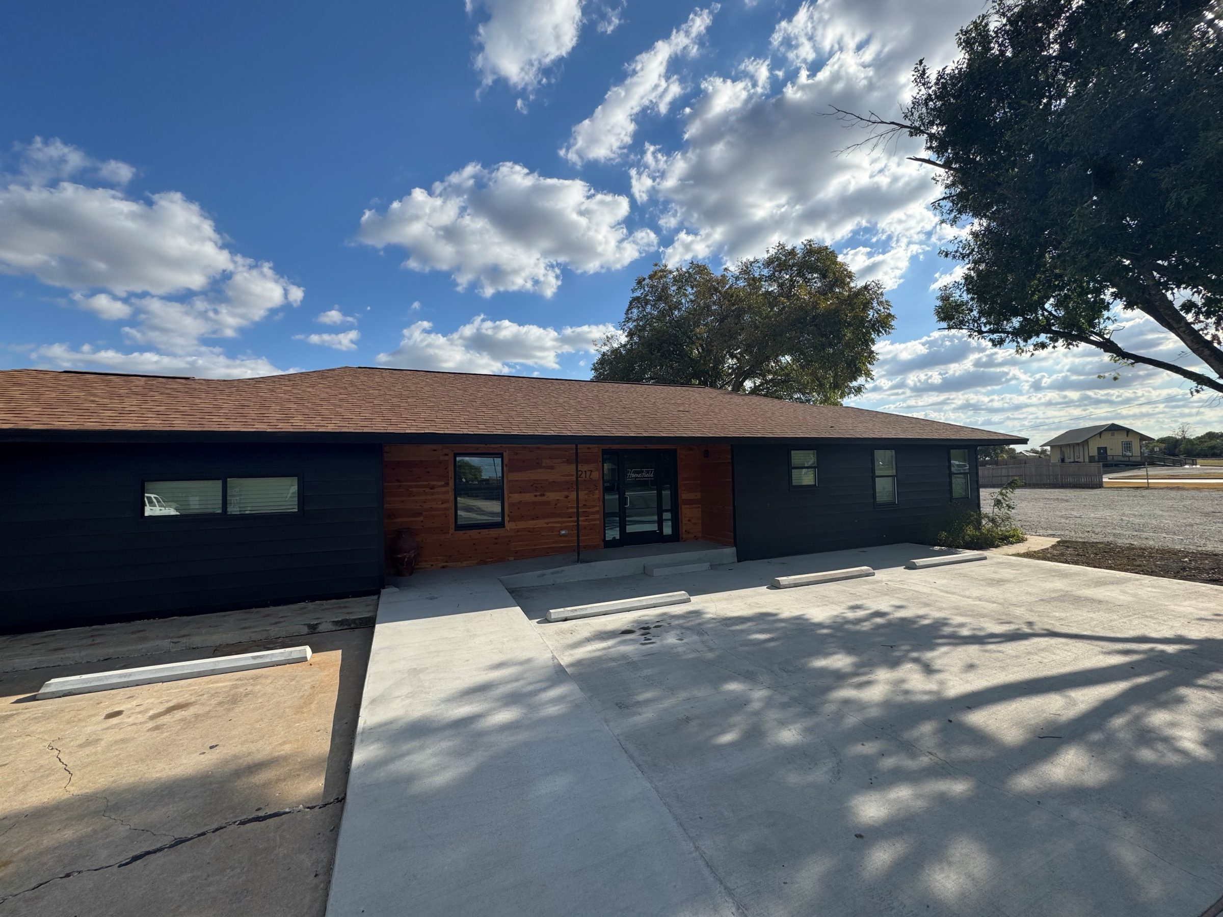 The Post — black and cedar exterior of the restored former Hewitt post office at 217 W Warren