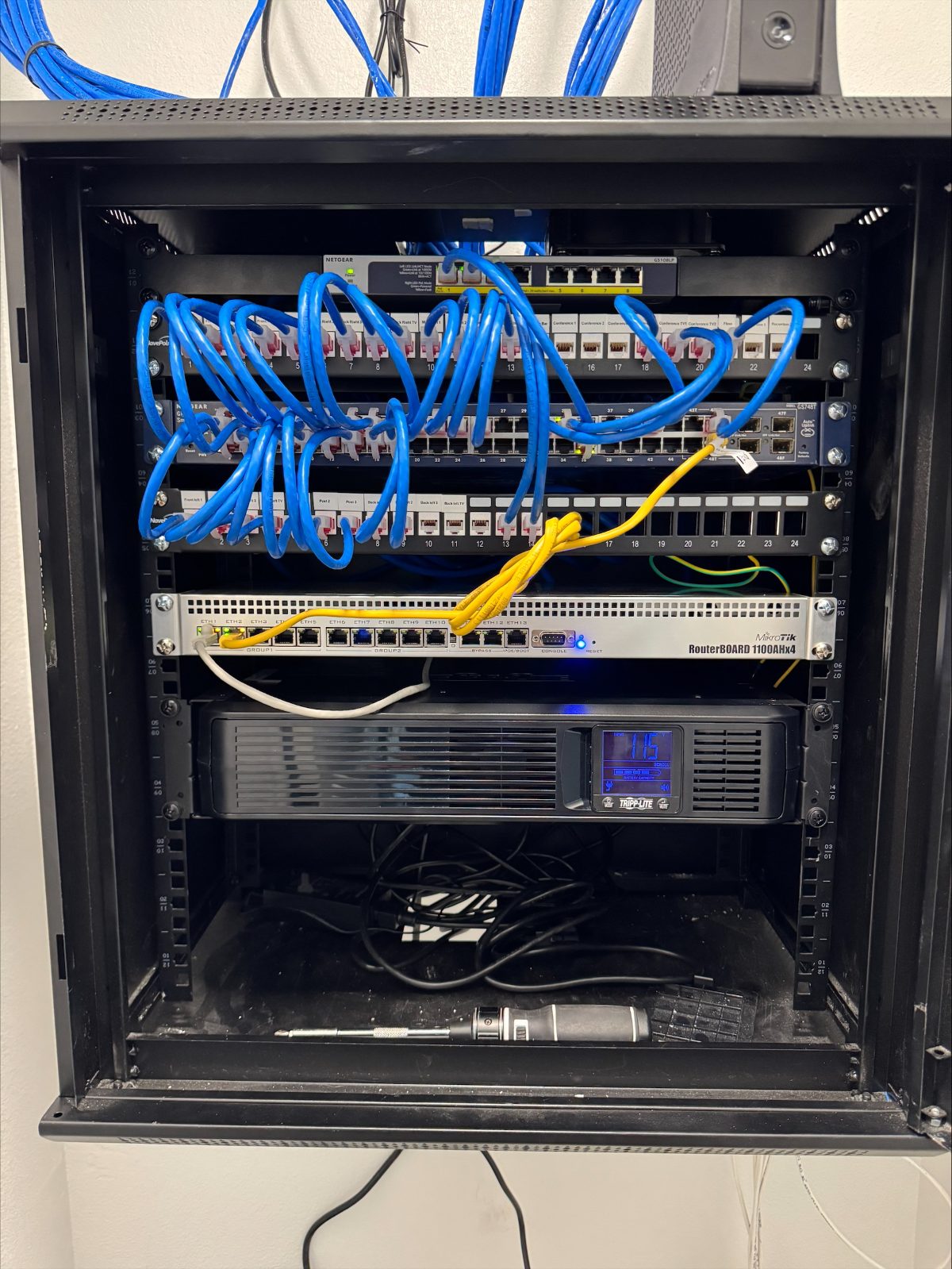 Network rack at The Post — patch panels, managed switches, MikroTik router and UPS